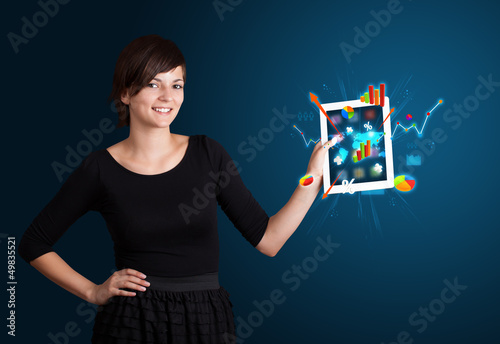 Photo: woman holding modern tablet with colorful diagrams and graphs woman holding modern tablet with colorful diagrams and graphs