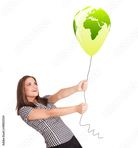 Photo: Happy lady holding a green globe balloon Happy lady holding a green globe balloon