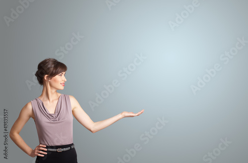 Photo: Pretty woman presenting copy space Pretty woman presenting copy space
