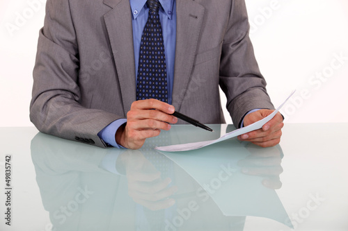 Photo: Close-up of man proof reading a document Close-up of man proof reading a document