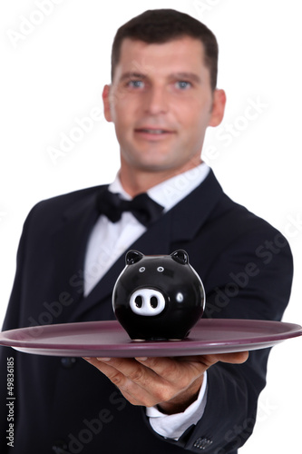 Photo: Waiter serving a piggy bank Waiter serving a piggy bank