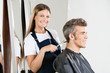Photo: Hairstylist Giving Haircut To Customer Hairstylist Giving Haircut To Customer
