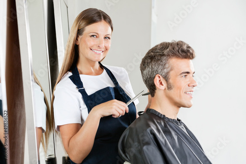Photo: Hairstylist Giving Haircut To Customer Hairstylist Giving Haircut To Customer