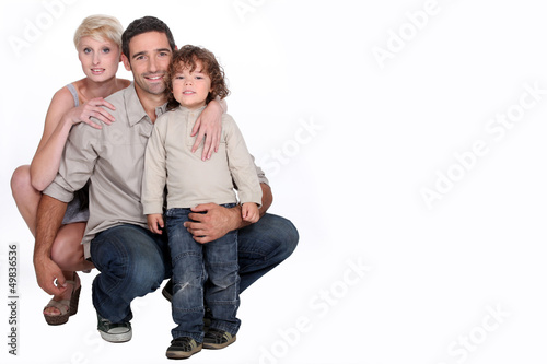 Photo: Studio shot of a young family Studio shot of a young family