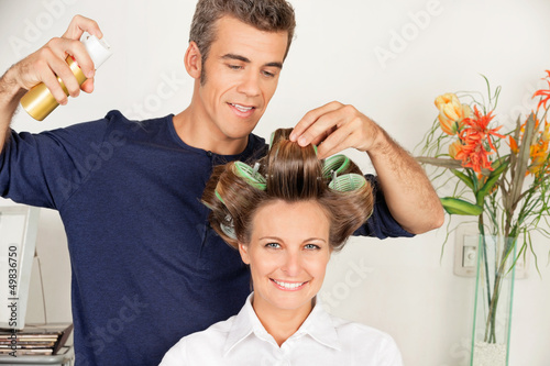 Photo: Client With Hairdresser Setting Curls With Hairspray Client With Hairdresser Setting Curls With Hairspray