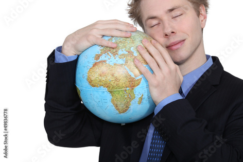 Photo: Businessman hugging a globe Businessman hugging a globe