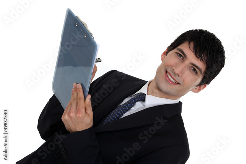 Photo: Businessman writing on clip-board Businessman writing on clip-board