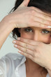 Photo: close shot of brunette with hands on face close shot of brunette with hands on face