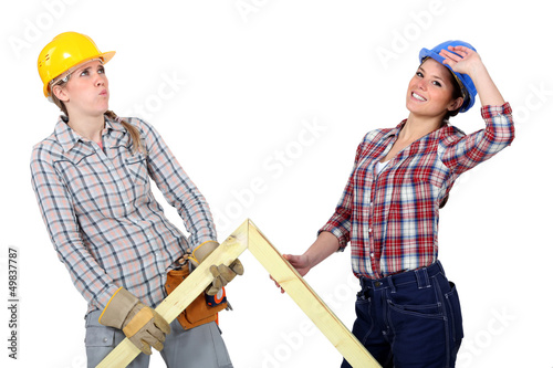 Photo: Women lifting wooden triangle Women lifting wooden triangle