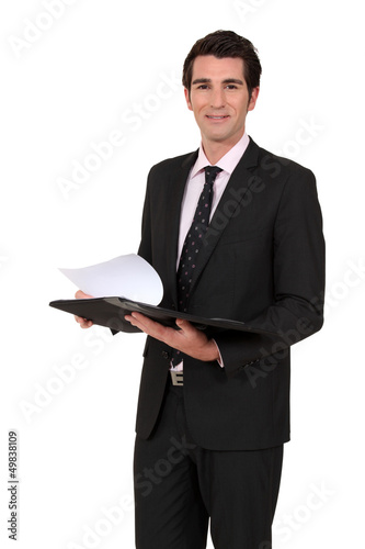 Photo: Businessman reading notes from meeting Businessman reading notes from meeting