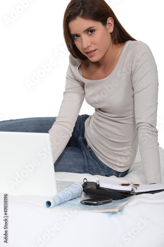 Photo: Woman sat with paperwork Woman sat with paperwork