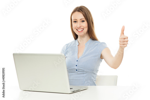 Photo: Woman with laptop showing thumbs up Woman with laptop showing thumbs up
