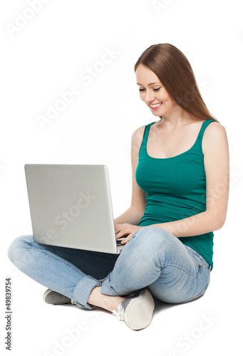 Photo: Young woman sitting with laptop Young woman sitting with laptop