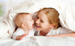 happy family. Mother and baby playing under  blanket