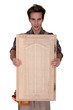 Carpenter holding wooden door