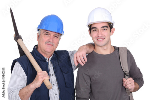 Photo: A mature construction worker and his grandson. A mature construction worker and his grandson.