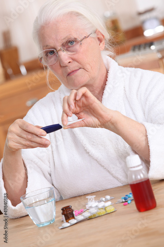 Photo: Old lady taking medication Old lady taking medication