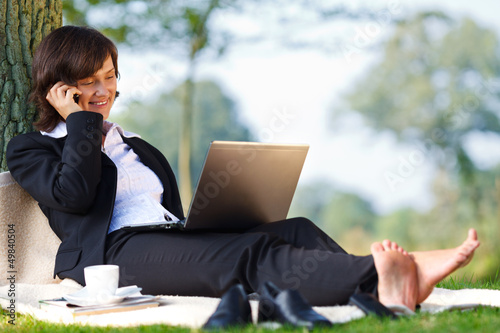Photo: businesswoman working outdoor in park businesswoman working outdoor in park