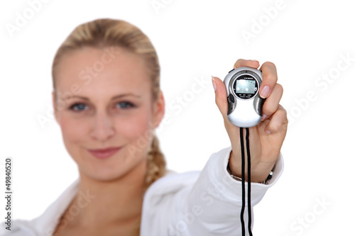 Photo: Woman holding stop watch Woman holding stop watch