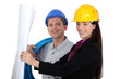 businesswoman and craftsman looking at a blueprint