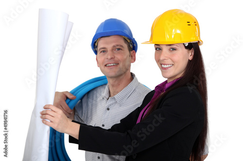 Photo: businesswoman and craftsman looking at a blueprint businesswoman and craftsman looking at a blueprint