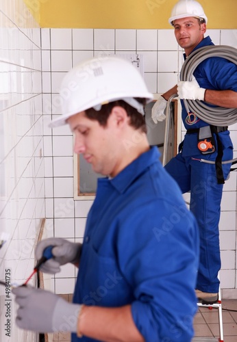 Photo: Electricians wiring a bathroom Electricians wiring a bathroom