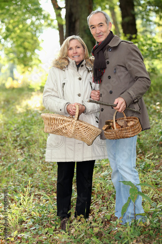 Photo: Couple collecting wild mushrooms Couple collecting wild mushrooms