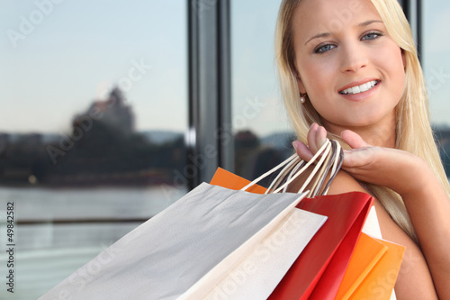 Photo: Young blond carrying shopping bags Young blond carrying shopping bags