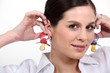 Woman with baby's dummies as earrings