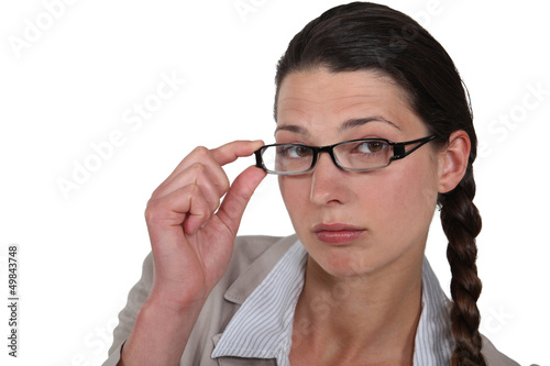 Photo: Woman adjusting her glasses Woman adjusting her glasses