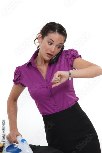 Photo: A working woman frantically looking at the time A working woman frantically looking at the time