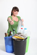 Brunette giving thumbs-up to recycling