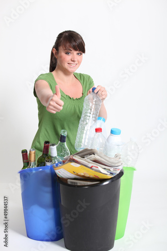 Photo: Brunette giving thumbs-up to recycling Brunette giving thumbs-up to recycling