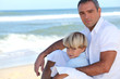 Father and son sitting on a beach