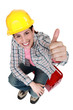 Happy girl sitting on a toolbox