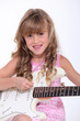Little girl playing guitar