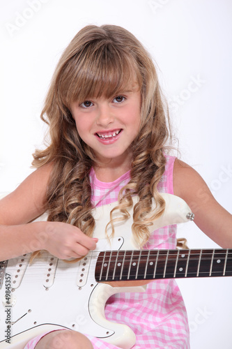 Photo: Little girl playing guitar Little girl playing guitar