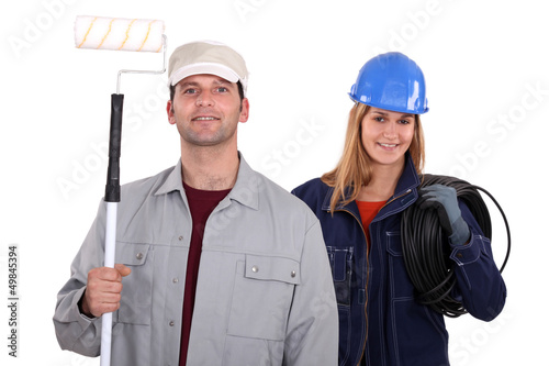 Photo: painter with roller and female electrician painter with roller and female electrician