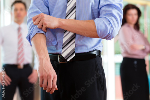 Photo: Business and people - roll up the sleeves Business and people - roll up the sleeves