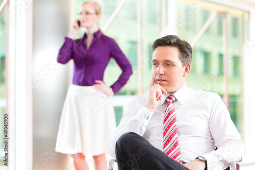 Photo: Business people - boss and secretary in office Business people - boss and secretary in office