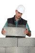 Photo: Bored tradesman laying cinder blocks Bored tradesman laying cinder blocks