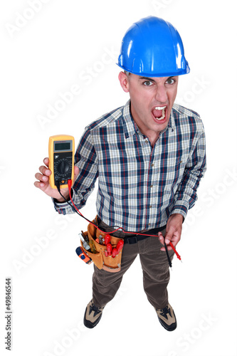 Photo: Man taking electrical reading Man taking electrical reading