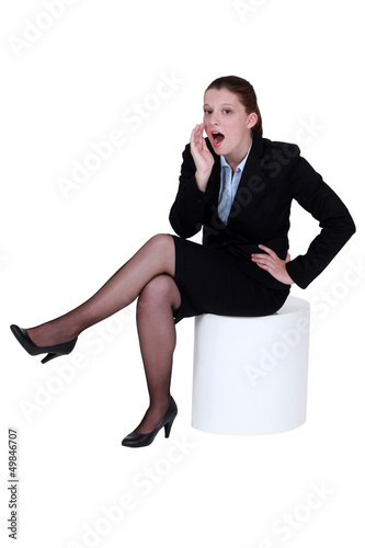 Photo: Woman telling a secret. Woman telling a secret.
