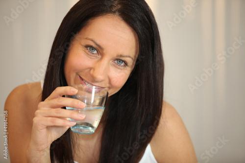 Photo: Woman drinking a glass of water Woman drinking a glass of water