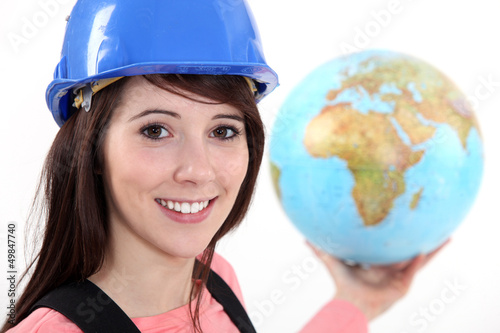 Photo: Tradeswoman holding a globe Tradeswoman holding a globe