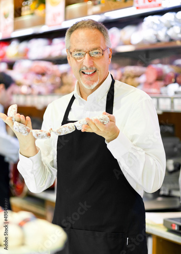 Photo: Shopkeeper serving a costumer Shopkeeper serving a costumer