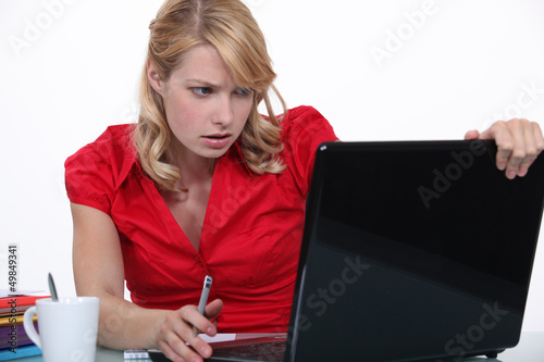 Photo: Woman having a problem with her laptop Woman having a problem with her laptop