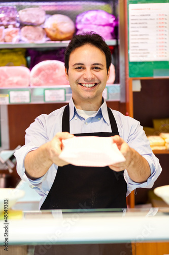 Photo: Shopkeeper serving a costumer Shopkeeper serving a costumer