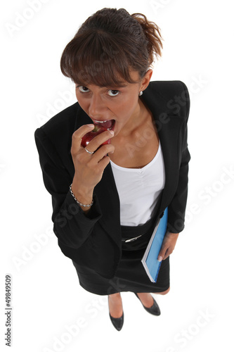 Photo: Businesswoman eating apple Businesswoman eating apple