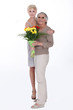 Woman giving her mother flowers